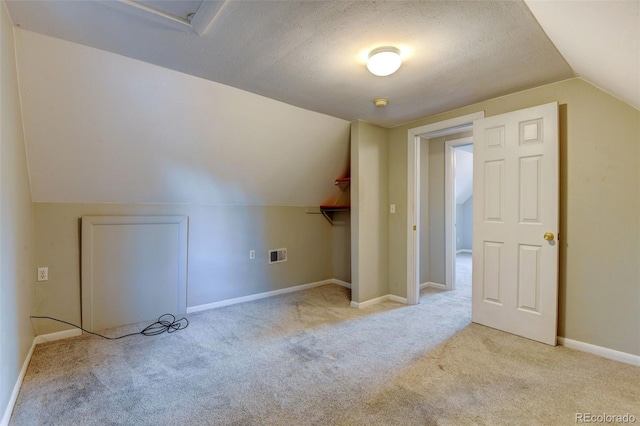 1707 W 39th Ave, Denver, CO 80211 - bonus room featuring carpet flooring, vaulted ceiling, and a textured ceiling