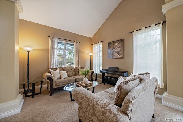 15258 W 75th Pl, Arvada, CO 80007 - living area featuring light colored carpet, high vaulted ceiling, and baseboards