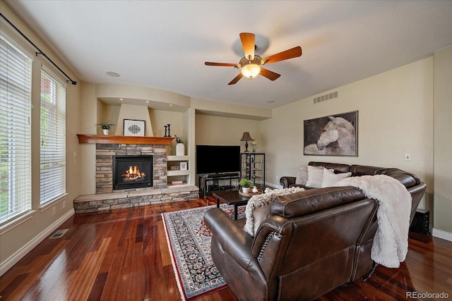 15258 W 75th Pl, Arvada, CO 80007 - living area featuring wood finished floors, ceiling fan, a stone fireplace, and baseboards