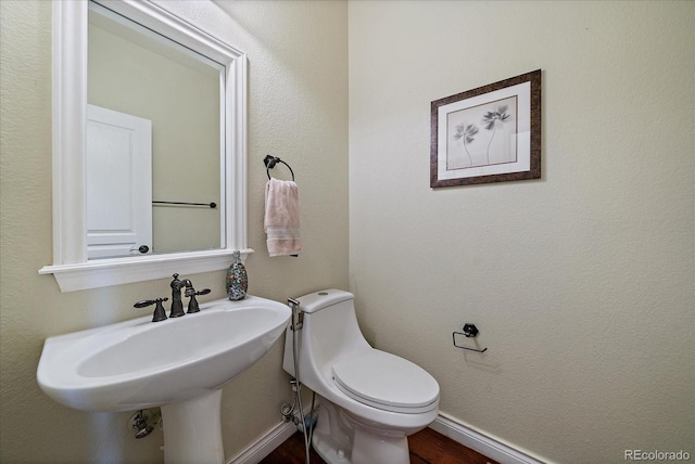 15258 W 75th Pl, Arvada, CO 80007 - half bathroom with toilet, a sink, and wood finished floors