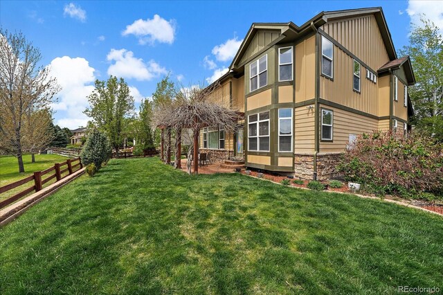 15258 W 75th Pl, Arvada, CO 80007 - rear view of house with stone siding, board and batten siding, a patio area, and a gazebo