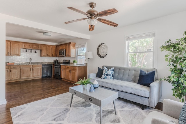 2260 Lilly Dr, Thornton, CO 80229 - living room with dark wood-style floors and a ceiling fan