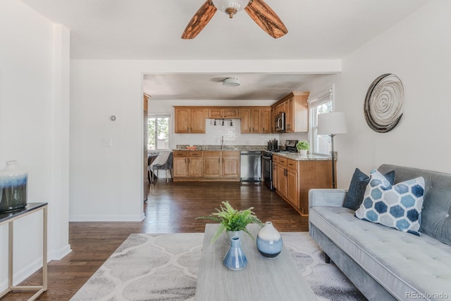 2260 Lilly Dr, Thornton, CO 80229 - living room with dark wood finished floors and a ceiling fan