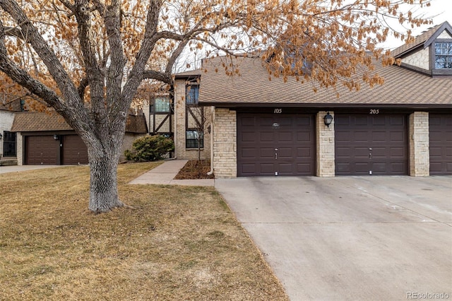 view of property with a front lawn, roof with shingles, and brick siding