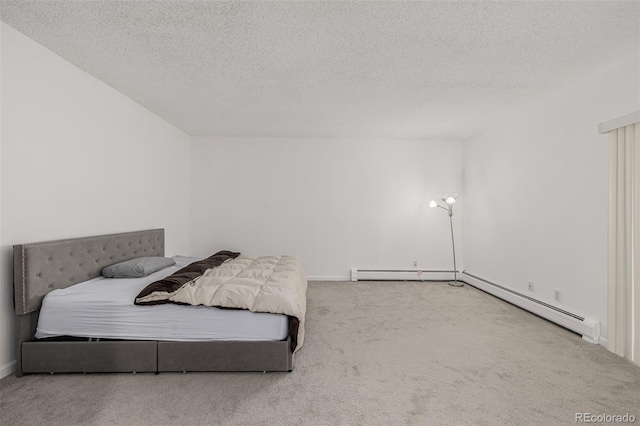 bedroom with a baseboard radiator, a textured ceiling, and carpet flooring