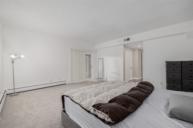 carpeted bedroom with a textured ceiling, a baseboard radiator, and visible vents