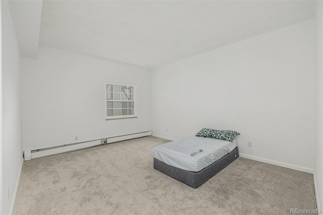 carpeted bedroom featuring baseboards and baseboard heating