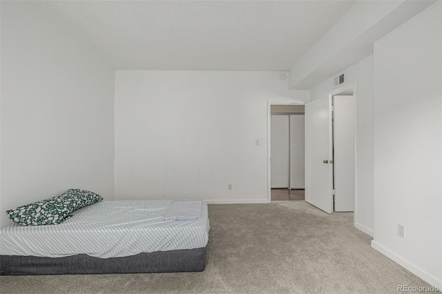 bedroom featuring carpet flooring, visible vents, and baseboards