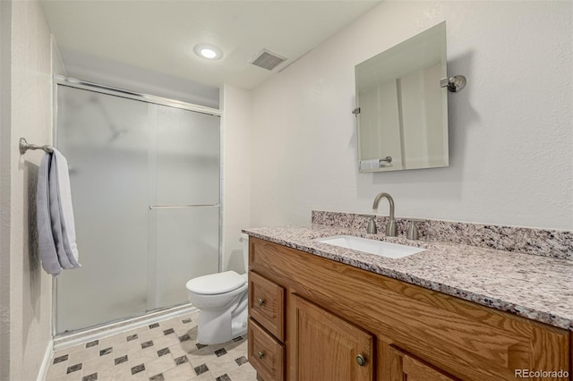 bathroom featuring visible vents, a shower stall, toilet, and vanity