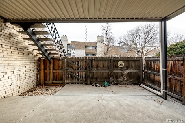 view of patio / terrace featuring fence and a gate