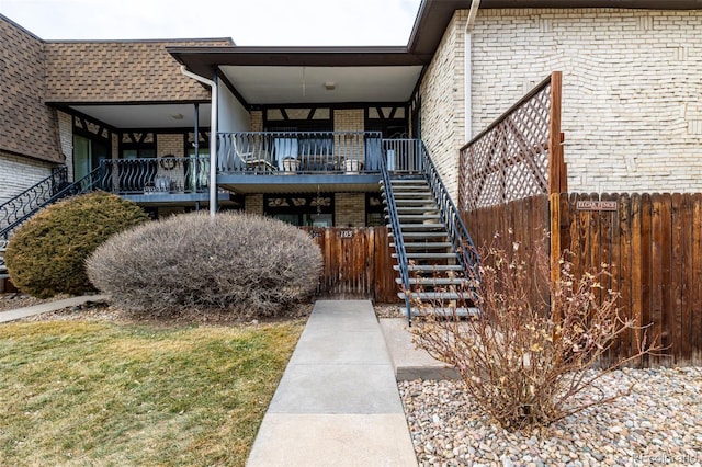 view of property featuring fence and stairs