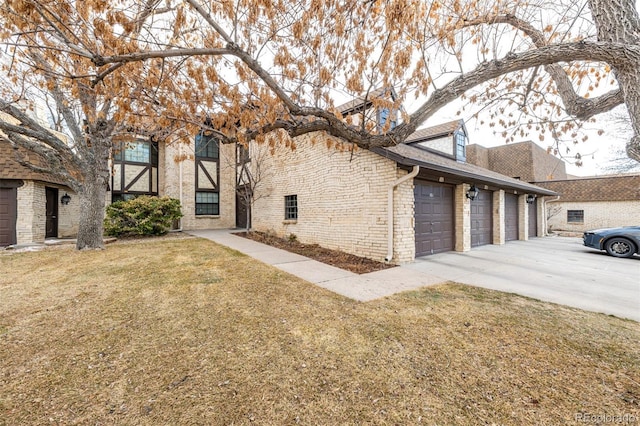 view of property exterior featuring a garage, a yard, and brick siding