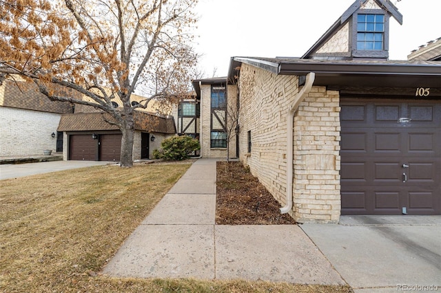 view of home's exterior featuring a garage, brick siding, and a yard