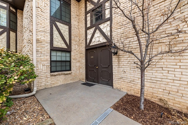 doorway to property with brick siding