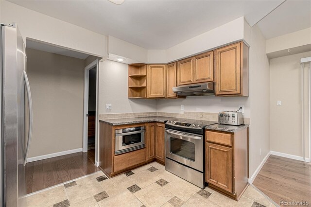 7250 Eastmoor Dr Unit 105, Denver, CO 80237 - kitchen with stainless steel appliances, under cabinet range hood, and brown cabinetry