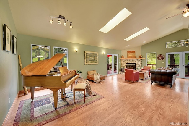 28065 Camel Heights Cir, Evergreen, CO 80439 - living area featuring healthy amount of natural light, lofted ceiling, french doors, and light wood-style floors