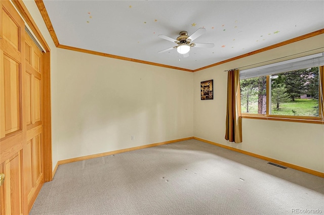 28065 Camel Heights Cir, Evergreen, CO 80439 - empty room featuring light colored carpet, baseboards, ceiling fan, and ornamental molding