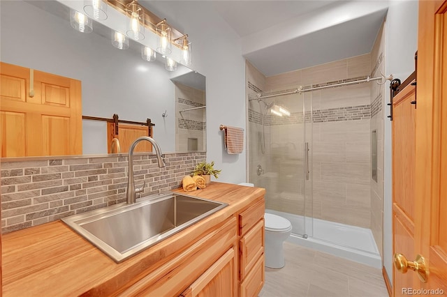 28065 Camel Heights Cir, Evergreen, CO 80439 - full bathroom featuring toilet, a shower stall, vanity, and backsplash
