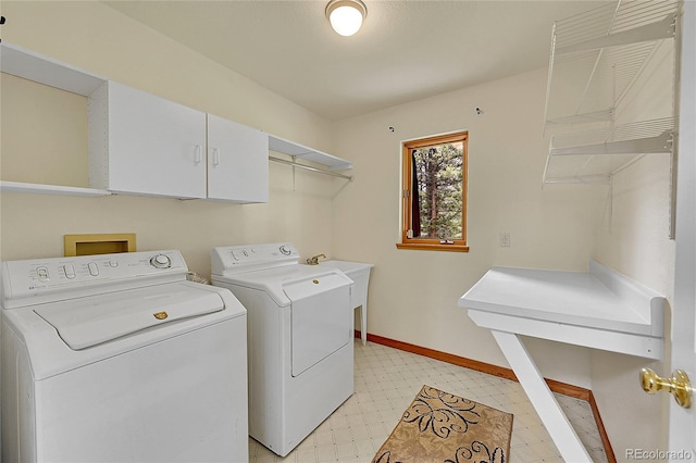 28065 Camel Heights Cir, Evergreen, CO 80439 - laundry room featuring washer and clothes dryer, light floors, cabinet space, and baseboards