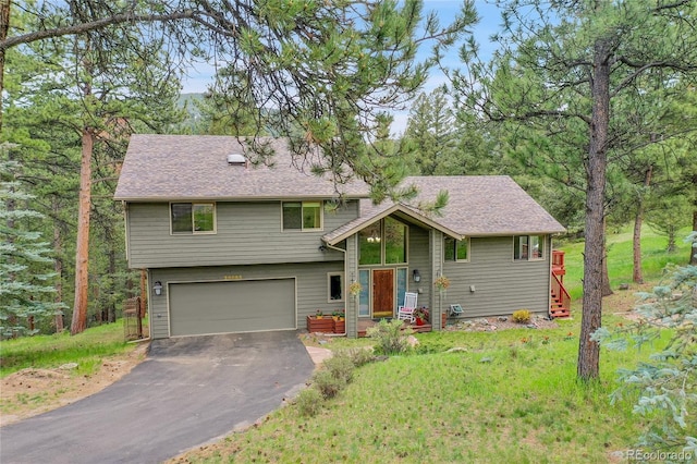 28065 Camel Heights Cir, Evergreen, CO 80439 - view of front facade featuring an attached garage, driveway, and a front lawn