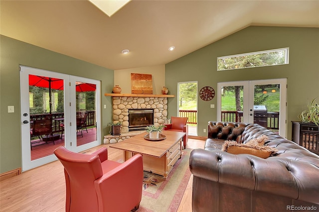 28065 Camel Heights Cir, Evergreen, CO 80439 - living area featuring french doors, light wood finished floors, plenty of natural light, and high vaulted ceiling