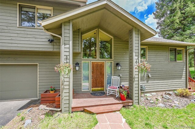 28065 Camel Heights Cir, Evergreen, CO 80439 - doorway to property featuring an attached garage