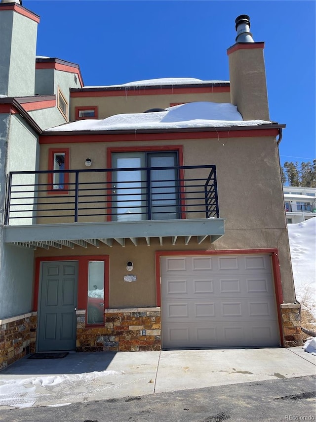 view of front of property with a balcony and a garage