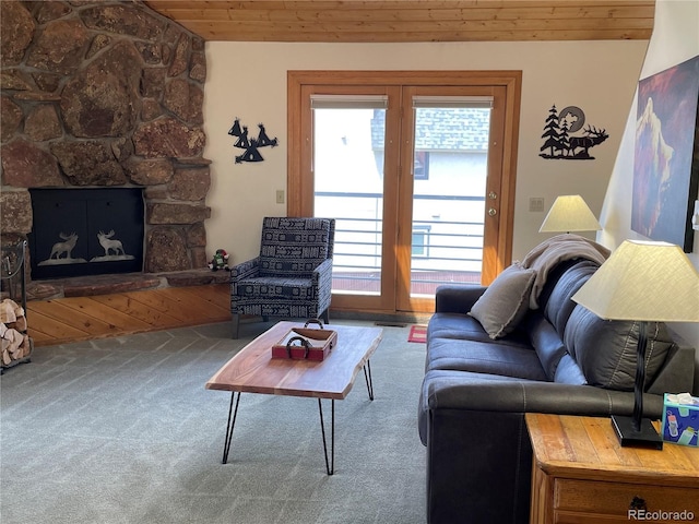 living room with a fireplace, wood ceiling, a wealth of natural light, and carpet flooring