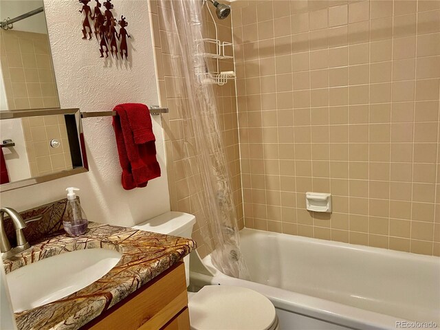 full bathroom with vanity, shower / tub combo with curtain, and toilet