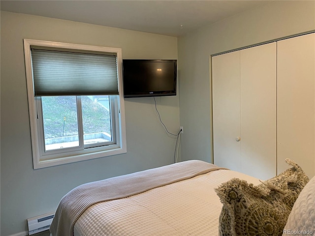 bedroom featuring a baseboard radiator and a closet