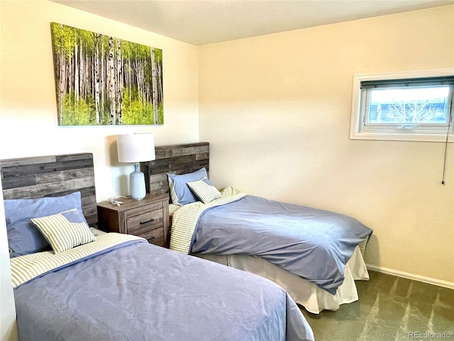 bedroom with dark colored carpet