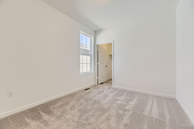 unfurnished room with light carpet