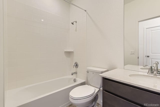 full bathroom with vanity, tiled shower / bath combo, and toilet