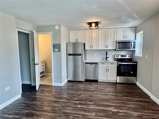 1285 Colorado Blvd Unit 3, Denver, CO 80206 - kitchen with stainless steel appliances, dark wood-style floors, white cabinets, backsplash, and a textured ceiling