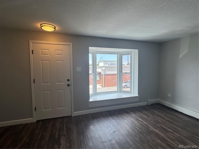 1285 Colorado Blvd Unit 3, Denver, CO 80206 - foyer entrance featuring dark wood-style floors and a textured ceiling