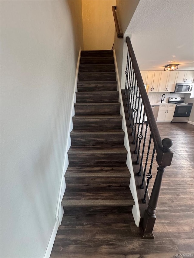 1285 Colorado Blvd Unit 3, Denver, CO 80206 - stairway with wood finished floors and a textured ceiling