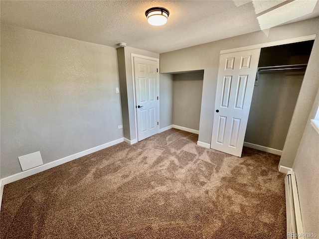 1285 Colorado Blvd Unit 3, Denver, CO 80206 - unfurnished bedroom with a baseboard heating unit, carpet floors, a textured ceiling, and a closet