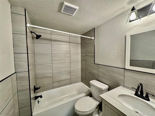 1285 Colorado Blvd Unit 3, Denver, CO 80206 - bathroom with tile walls, a textured ceiling, bathtub / shower combination, and vanity