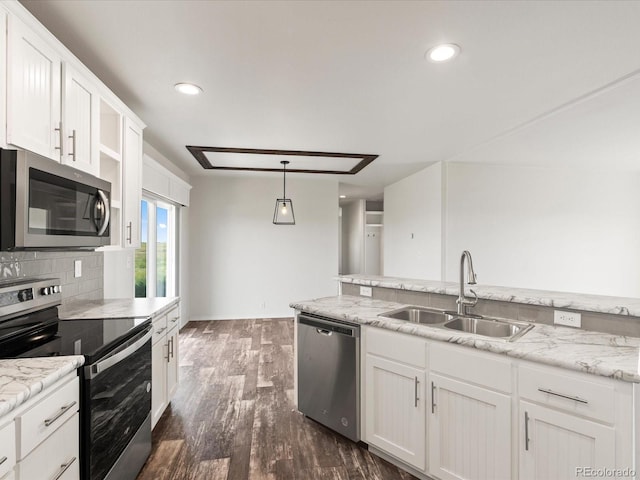 kitchen with white cabinetry, dark wood-type flooring, stainless steel appliances, decorative light fixtures, and sink