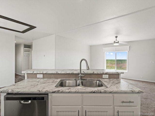 kitchen with dark colored carpet, stainless steel dishwasher, a kitchen island with sink, sink, and ceiling fan