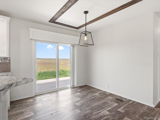 unfurnished dining area with dark hardwood / wood-style flooring