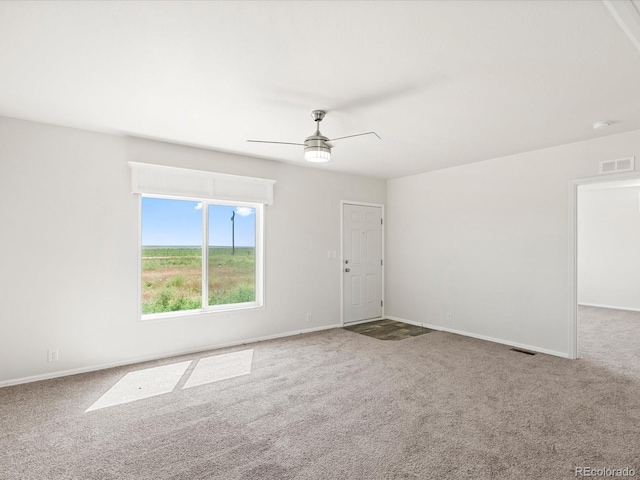 carpeted spare room with ceiling fan