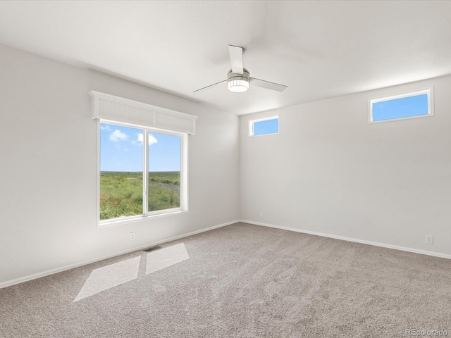 unfurnished room with ceiling fan and carpet floors