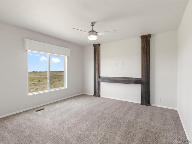 carpeted empty room featuring ceiling fan