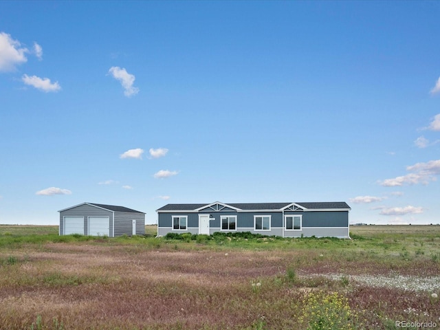 view of front of property featuring a garage and an outdoor structure