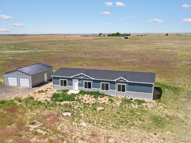 view of front facade featuring a rural view, an outdoor structure, and a garage