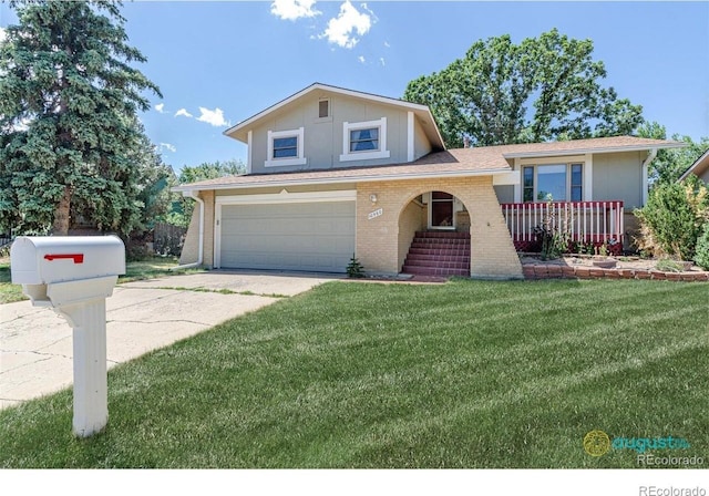 split level home featuring brick siding, an attached garage, driveway, and a front lawn