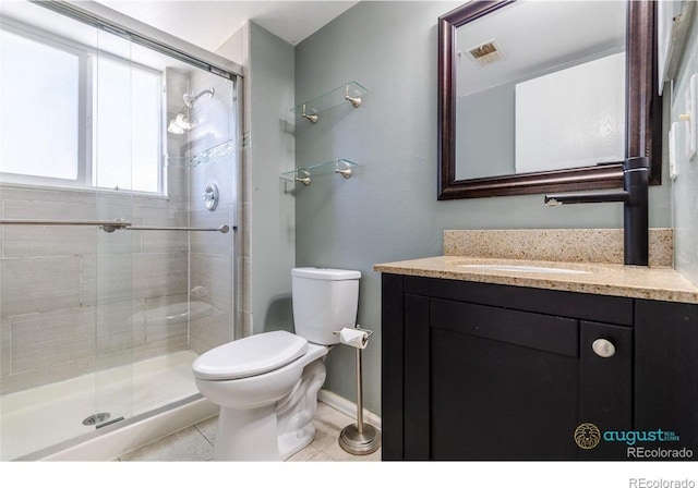 bathroom with toilet, a shower stall, tile patterned flooring, and vanity