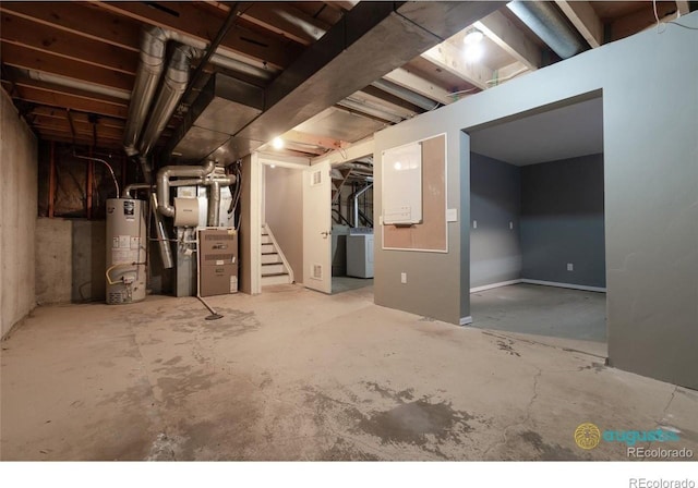 unfinished basement with water heater, washer / dryer, heating unit, and stairway