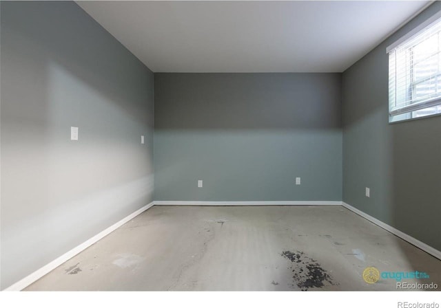 spare room with baseboards